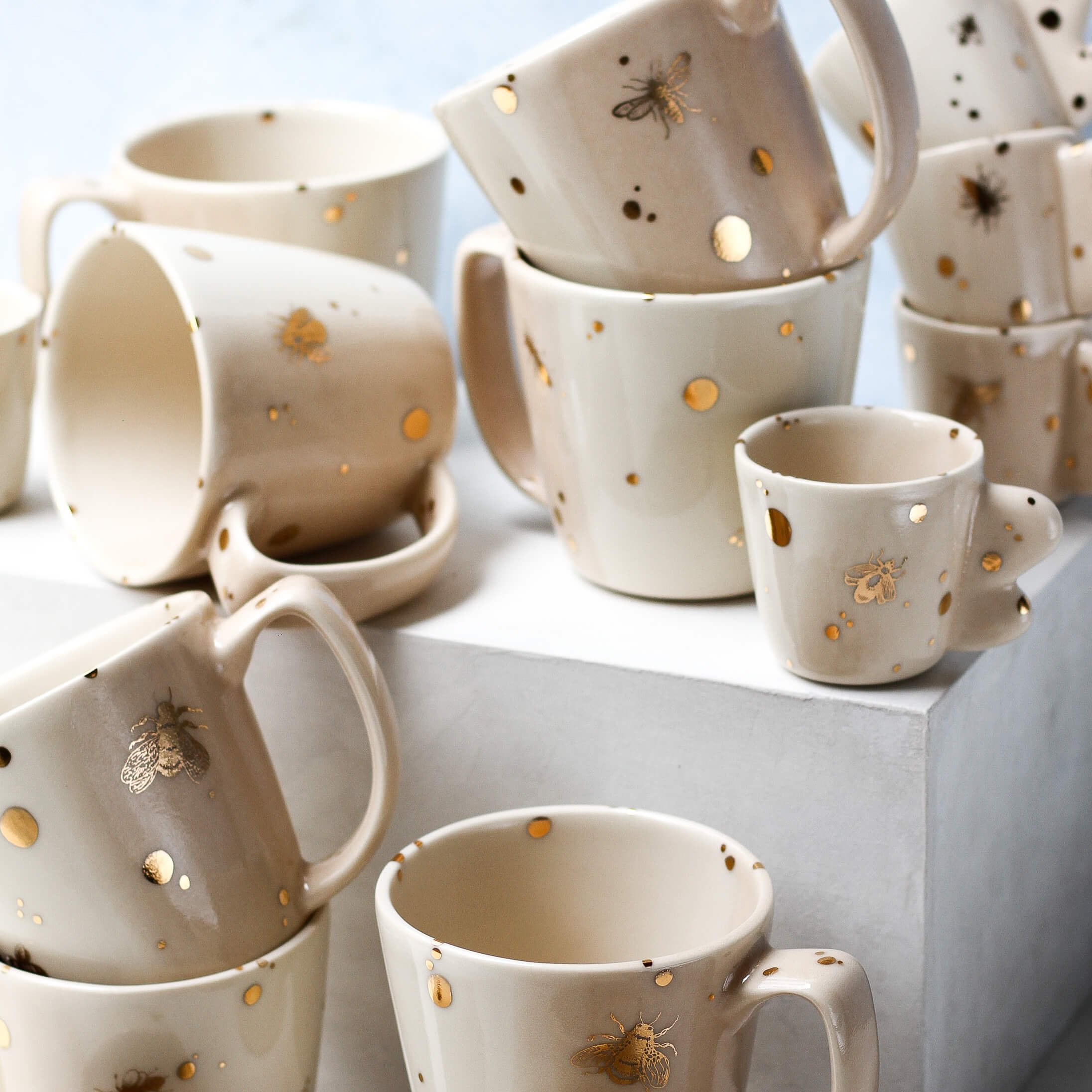 A group of Drops of Honey Bee mugs and espresso cups