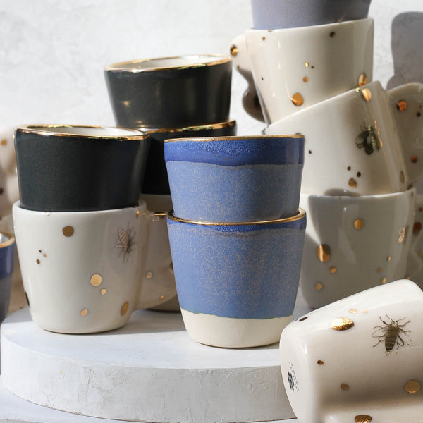 A collection of espresso cups and shot glasses in a variety of glazes by apricity ceramics