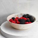 Drops of Honey bee granola bowl with raspberries and blackberries