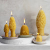 Beeswax candles lit of trinket dishes